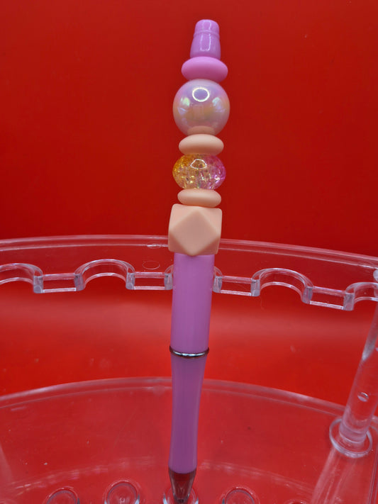 Pink pen with skin tone bead
